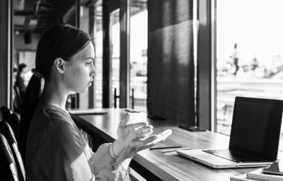 Side view of woman using sign language during video call