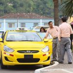 Unidentified taxi drivers talking at taxi stand on 12 de Noviembre Street outside the cathedral