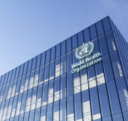 World Health Organization Signage Logo on Top of Glass Building.