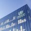 World Health Organization Signage Logo on Top of Glass Building.