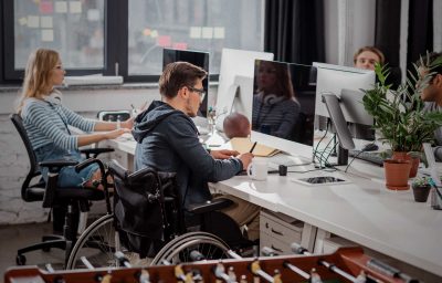 man in wheelchair working in the office