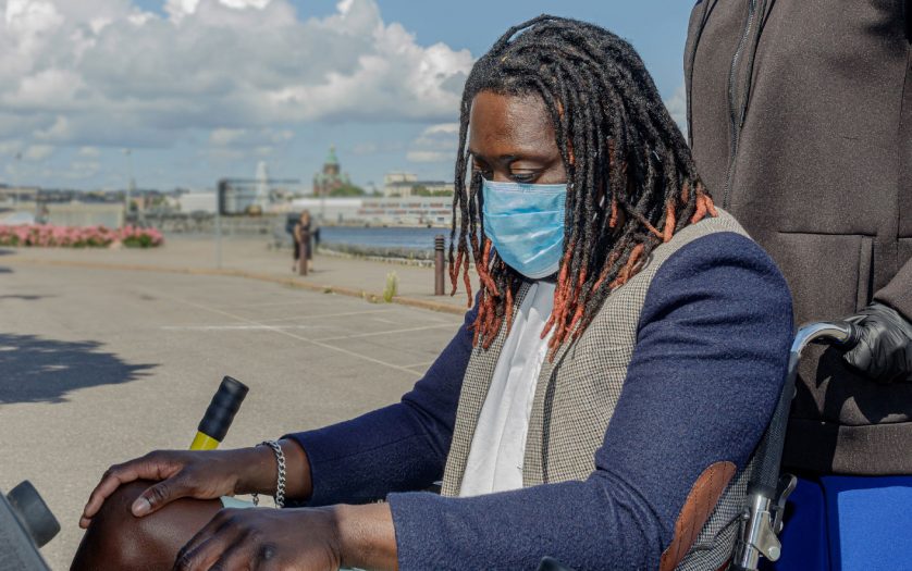 African man in wheelchair wear a medical mask to protect themselves from the coronavirus outbreak