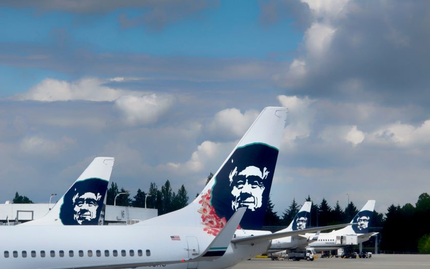 Alaska Airlines jets at the Seattle Airport waiting to be loaded with passengers and luggage.
