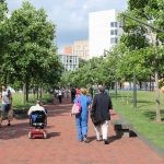 Wheelchair user and people walk in campus of Pennsylvania State University in Philadelphia.