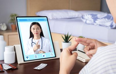 Deaf patient use video conference, make online consultation by sign language with doctor on tablet
