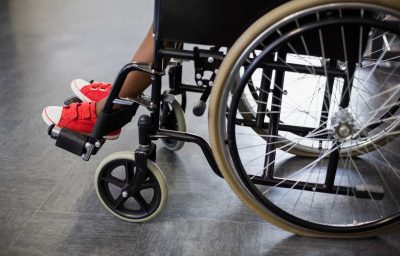 Boy sitting on wheelchair