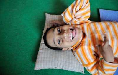 12 years old Suraj Raghuvansi with cerebral palsy smiling at Rehab Center in Bhopal.
