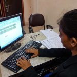indian female office incharge working on personal computer in India