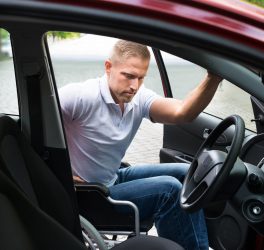 man in wheelchair boarding the car