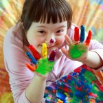 Cute little girl with painted hands