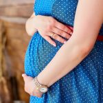Pregnant woman holding her belly