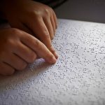 person reading braille