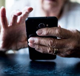Close up of senior woman using mobile phone.