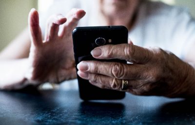 Close up of senior woman using mobile phone.