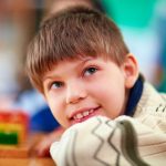 Portrait of young smiling boy with disabilities