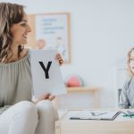 teacher having a lesson with school little boy