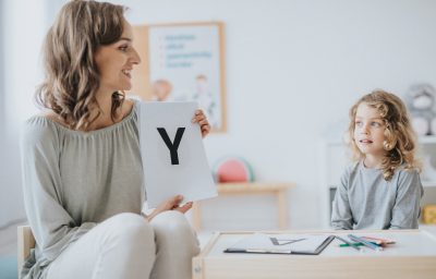 teacher having a lesson with school little boy