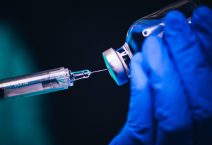 Vaccine shot drug needle syringe on black background