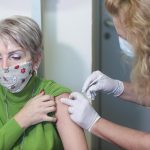 woman receives a dose of the Pfizer-BioNTech Covid-19 vaccineat the AHEPA hospital in Thessaloniki