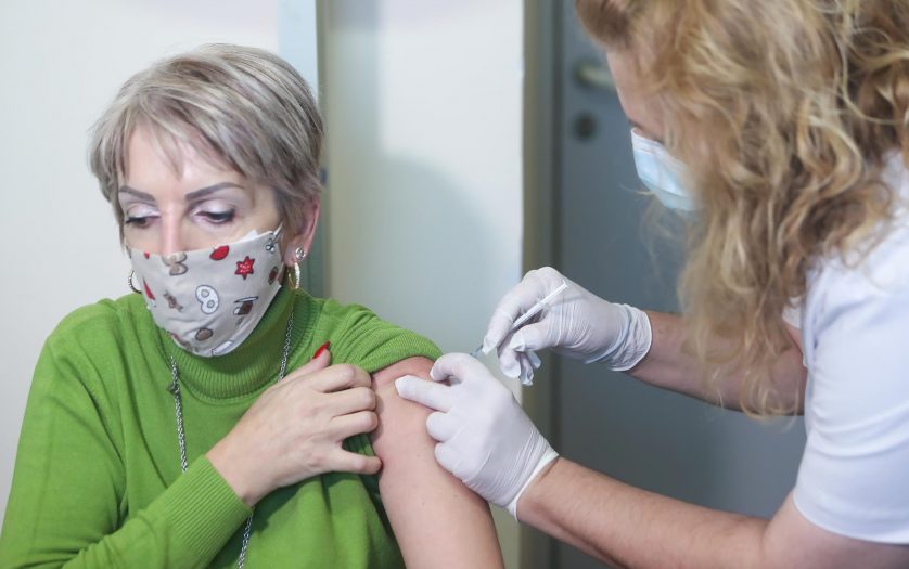 woman receives a dose of the Pfizer-BioNTech Covid-19 vaccineat the AHEPA hospital in Thessaloniki