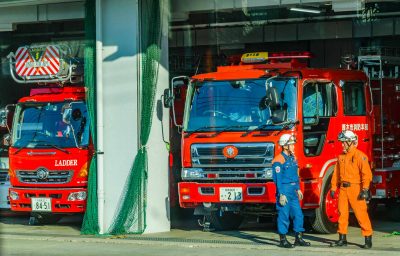 Two men talking at fire station in kanagawa prefecture, japan