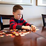 boy working on a jigsaw puzzle