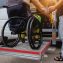 Man in wheelchair using accessible vehicle with lift mechanism