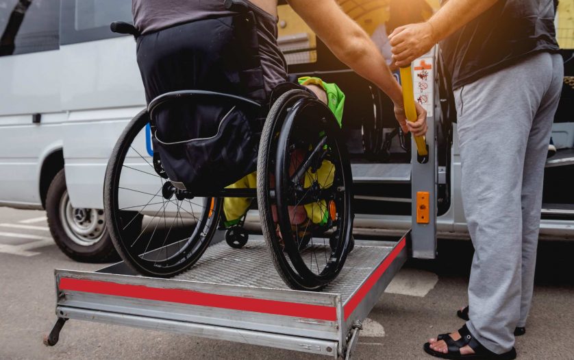 Man in wheelchair using accessible vehicle with lift mechanism