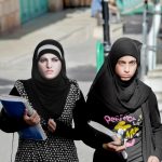 Female students walking down the street in Bethlehem, Palestine.