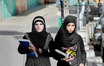 Female students walking down the street in Bethlehem, Palestine.