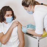 Woman doctor gives a vaccine to patients