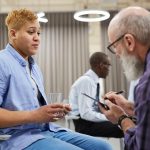Side view portrait of mature man consulting masculine woman in therapy session
