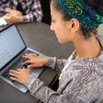 student girl learning online, doing research, using a laptop computer