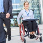 businesswoman in wheelchair on departure after meeting