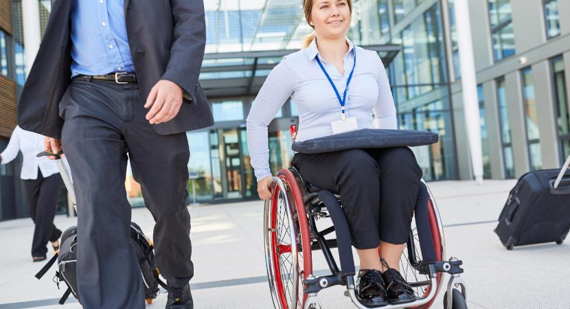 businesswoman in wheelchair on departure after meeting