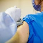 Close up of person receives the Pfizer vaccine for covid-19.
