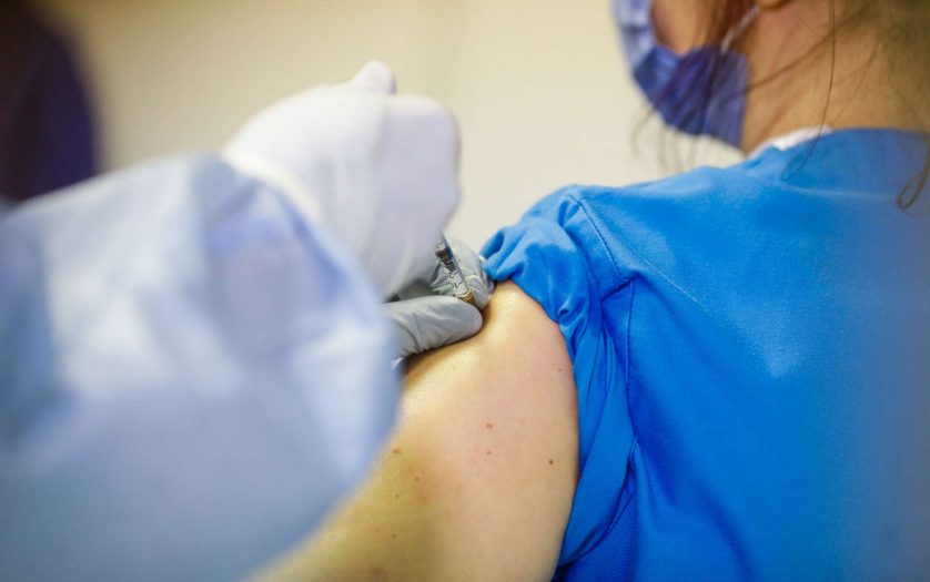 Close up of person receives the Pfizer vaccine for covid-19.