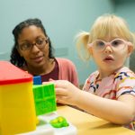 girl with autism with researcher