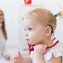 Baby girl wearing a hearing aid.