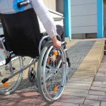 Woman in a wheelchair using a ramp