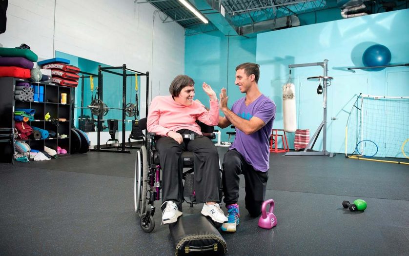 trainer with woman in wheelchair