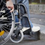 Man on a wheelchair in from of flight of steps