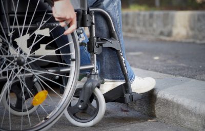 Man on a wheelchair in from of flight of steps