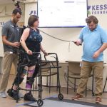 woman with Robotic exoskeleton suit walking