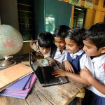 Students are learning with the help of a laptop at the rural school in West Bengal, India