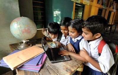 Students are learning with the help of a laptop at the rural school in West Bengal, India