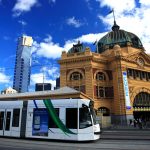 Cable car passing the historic train station/Flinders Station