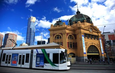 Cable car passing the historic train station/Flinders Station
