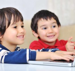 Two young children with laptop