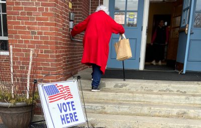 Old Woman Voter Entering Voting Polling Place for USA Government Election